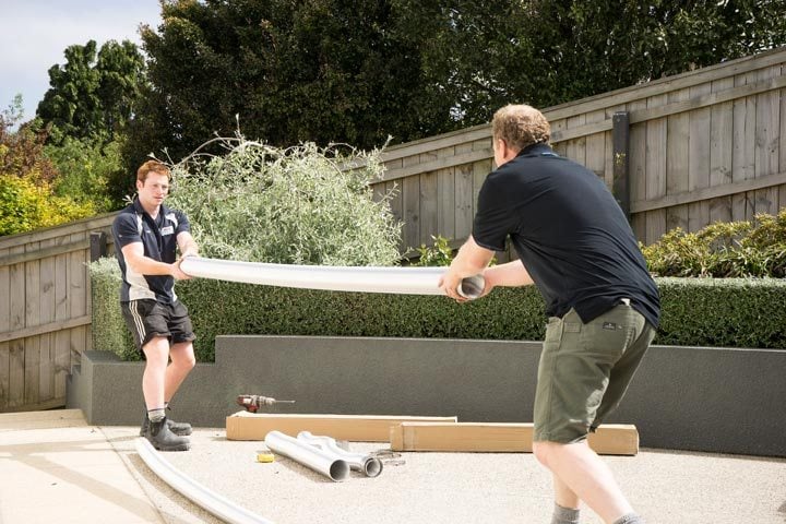 Two workers stretching Flue