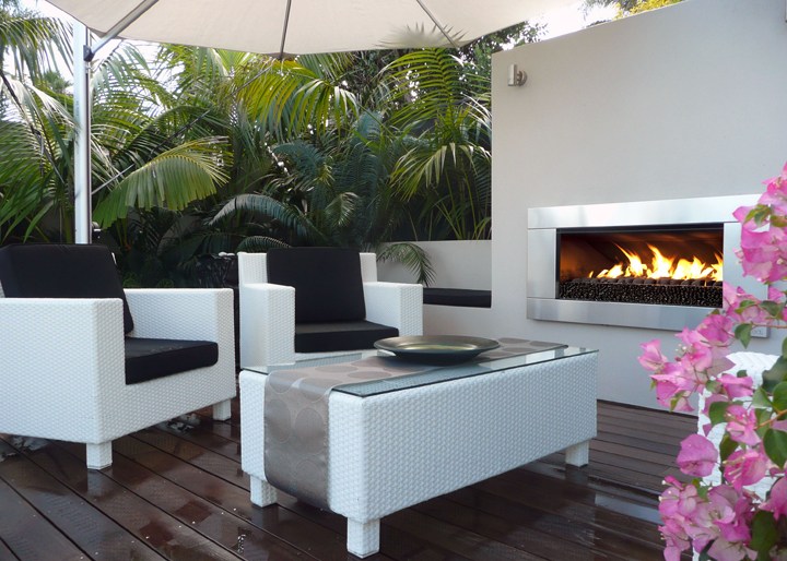 A Lush Palm-Fringed Courtyard with a Fireplace